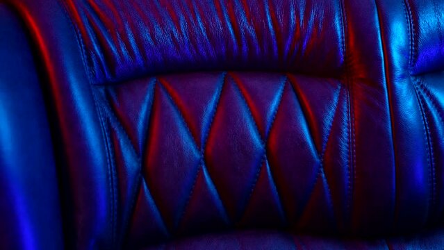 details of expensive natural leather couch for home and office, closeup view in mysterious darkness