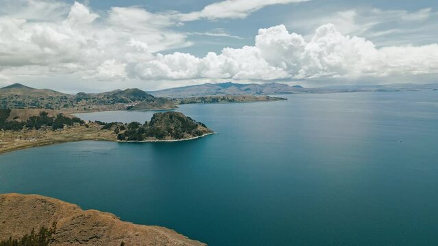 Capturing the essence of harmony between man and nature, this captivating drone footage of Titicaca Lake showcases a serene hamlet and breathtaking agricultural terraces.