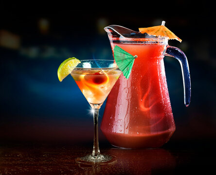 Sea Breeze cocktail and pitcher against black background