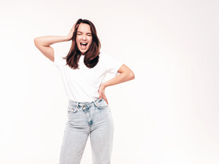 Young beautiful woman. Trendy carefree model in casual summer white T-shirt and jeans. Positive female isolated on white in studio. Cheerful and happy. Copy space, mockup. Screams, shouts