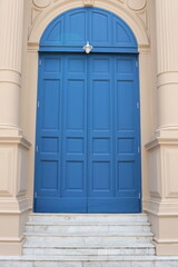 Wood painted blue door closed and stair in retro style.