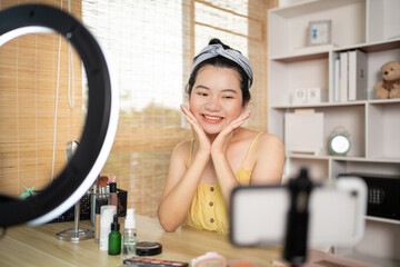 Beautiful woman with a social media influence is greeting the audience for recording vlog video...