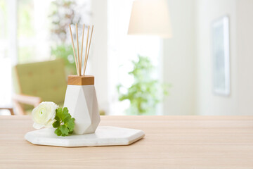 Aroma reed diffuser with rattan sticks on defocused room background