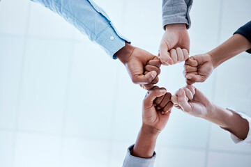 Business people, fist circle and teamwork in low angle, team building and trust in office. Solidarity, huddle and group or staff of men and women with hands together for unity, synergy or cooperation - obrazy, fototapety, plakaty