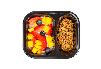 Dessert of cream, mango, strawberries and muesli on a white background.