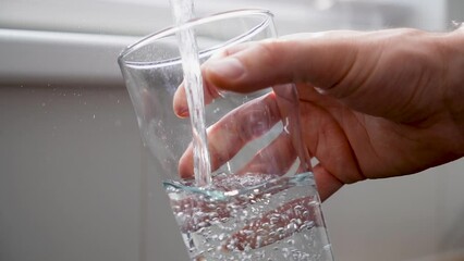 Man pouring clean tap drinking water into the clean glass on sunny day. - Powered by Adobe