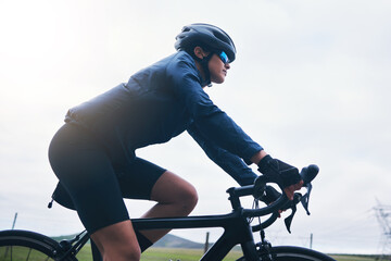 Woman, bicycle athlete and cycling on sky mockup outdoor, exercise and training for triathlon....