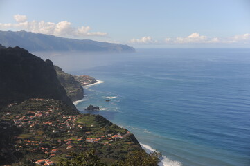 Picturesque view from the mountain on a village at the coastline of Atlantic Ocean on Madeira Island, Portugal