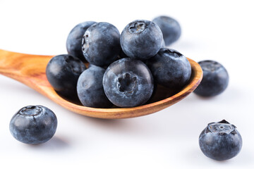 Fresh blueberries in wooden spoon