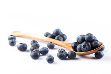 Fresh blueberries in wooden spoon