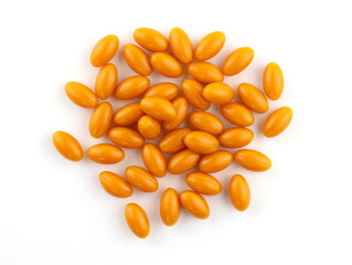 Oval orange capsules on a white background. Capsules in gelatin shell Q10 top view. Food supplement for brain activity. oval capsules with vitamins.