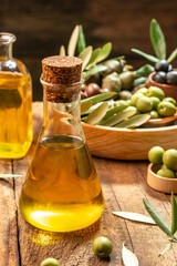 extra virgin olive oil in glass bottles on a wooden background. Healthy and detox food concept. place for text