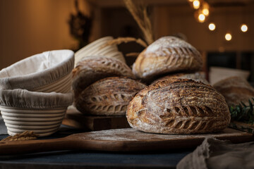 Artisan Batard Sourdough healthy Bread with leaf scoring. Open crumb high hydration Sourdough bread set on white table. - 594565137