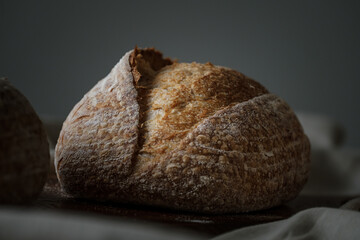 Artisan Batard Sourdough healthy Bread. Open crumb high hydration Sourdough french country bread set on dark background. - 594565186