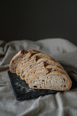 Artisan Batard Sourdough healthy Bread. Open crumb high hydration Sourdough french country bread set on dark background. - 594565197
