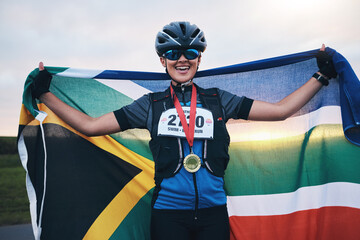 Winner sports, happy woman from South Africa with flag and gold medal winning, outdoor cycling race...