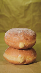delicious Freshly Baked bomboloni with custard on plate held by women pastry doughnuts day