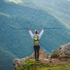 Young woman n the top of the mountains