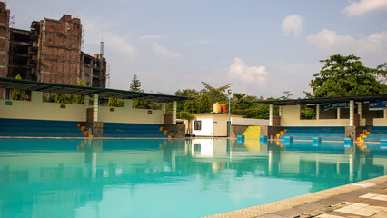 An empty swimming pool, without swimmers, chairs or parasols, leaving a calm and peaceful atmosphere with a depth of up to 230 cm and a canteen