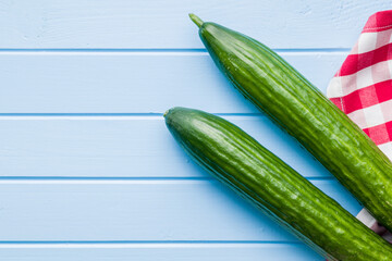 Fresh green cucumbers on kitchen table. Top view.