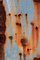Rusted steel plate. Abandoned house, ruins. Metal. Background material. Stone, rock, etc…
