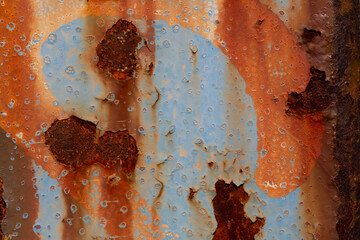 Rusted steel plate. Abandoned house, ruins. Metal. Background material. Stone, rock, etc… Blue and Orange.