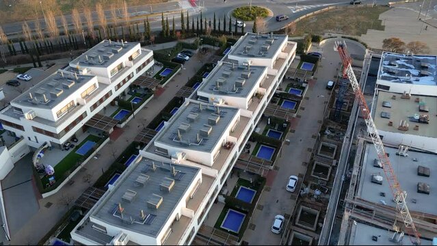 Aerial drone view over a residential area: modern real estate construction. Sustainable buildings in the suburb for a better future