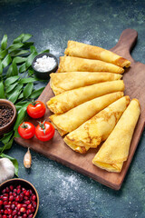 front view tasty pancakes rolled on a dark background pastry hotcake dough pie meat color sweet cake meal