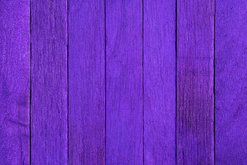 Old purple wooden background. Wooden textured background. Wooden painted lilac boards are located vertically in a row.