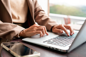 Woman working on laptop and enjoying the beautiful nature landscape with mountain view. Technology and lifestyle, 5G concept. Closeup