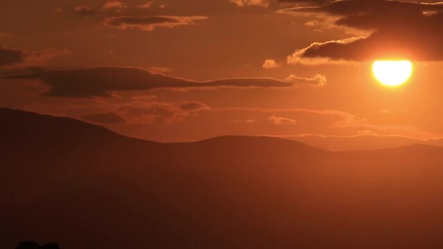 The sun hides behind the clouds in Paros island in Greece