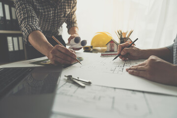 Architects, engineers, contractors working in the office with blueprints, inspection engineers Work analysis for architectural plan, construction project sketch, focus, business construction concept.