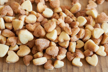 Cookies in the shape of hearts on a wooden background.