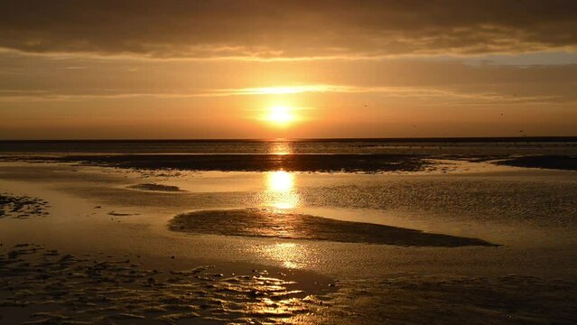 Colorful sunset at the beach of Schiermonnikoog island in the Dutch Waddensea region in the North of The Netherlands.