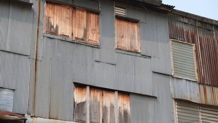 Buildings partially covered in corrugated iron sheets and wooden planks