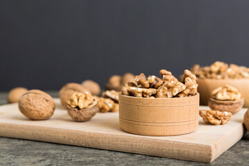 Fresh healthy walnuts in bowl on colored table background. Top view Healthy eating bertholletia concept. Super foods