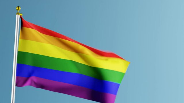 Animation of waving rainbow pride flag against blue background,close up