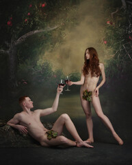 Cinematic portrait of picture Adam and Eve. Young man and woman, famous characters holding wine glasses and drinking alcohol over vintage background. Party - obrazy, fototapety, plakaty