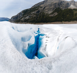 Beautiful glaciers flow through the mountains. Close up blue glacier river.