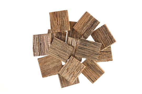 Overhead view of cut agarwood chips (Aquilaria agallocha), also called aloeswood, eaglewood or Oudh, isolated on white background