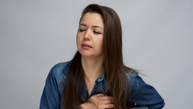 Woman feeling heart attack, close-up