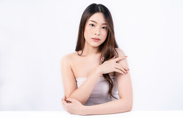 Portrait of facial beauty asian woman applying a lotion to arm hand touch skin during dressing up....