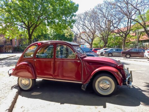 old red burgundy popular Citroen 3CV 1960-1979 in the street in 
