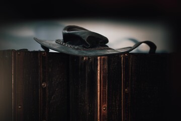 Brown cowboy hat resting on a wooden surface