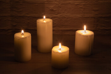 Fototapeta na wymiar photo of several lit candles standing on a table