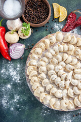 top view little raw dumplings with flour and vegetables on the dark background meat dough food dish calorie meal color bake vegetable