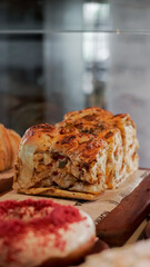 delicious and warm fresh baked bread with fluffy meat filling on a bakery shop display, ready to sel