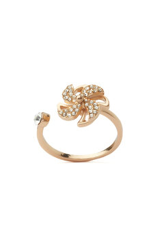 Close-up shot of a gold ring decorated with sparkling crystals and decorative elements. Open ring is isolated on a white background. Front view.