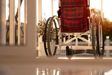 Wheelchair of person with disability in the house or hospital with nature sunlight, Cinematic tone and emotion picture, Life Insurance accident, International Day of Persons with Disabilities concept.