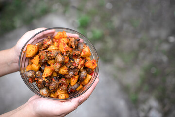 a bowl of sambal from chicken liver and potato wedges